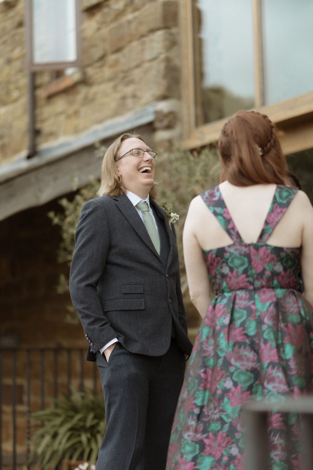 A formal event shows two people sharing a candid moment outdoors, at Crockwell Farm wedding