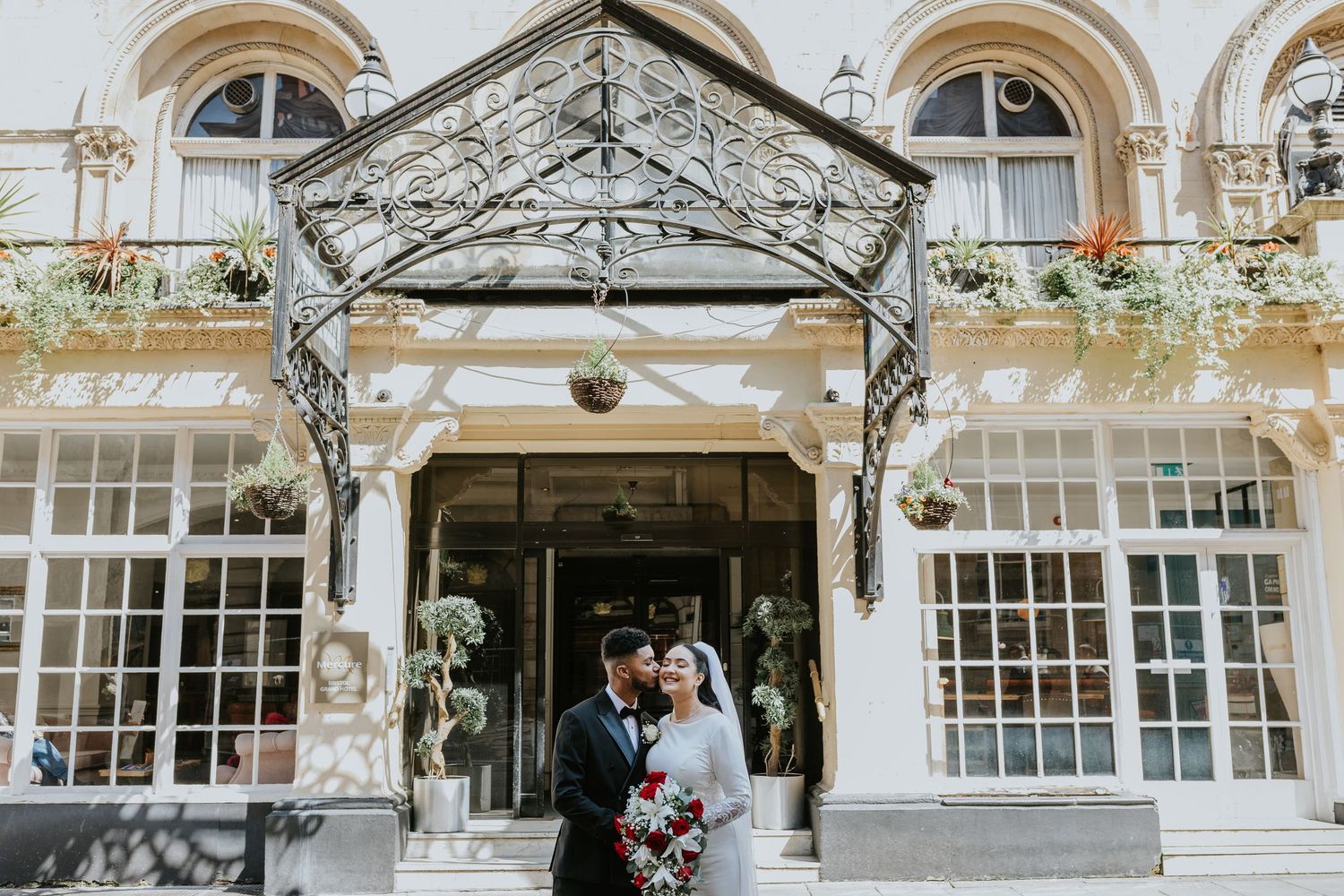 Beautiful historic building facade with ornate iron canopy and arched windows makes an elegant architectural backdrop.