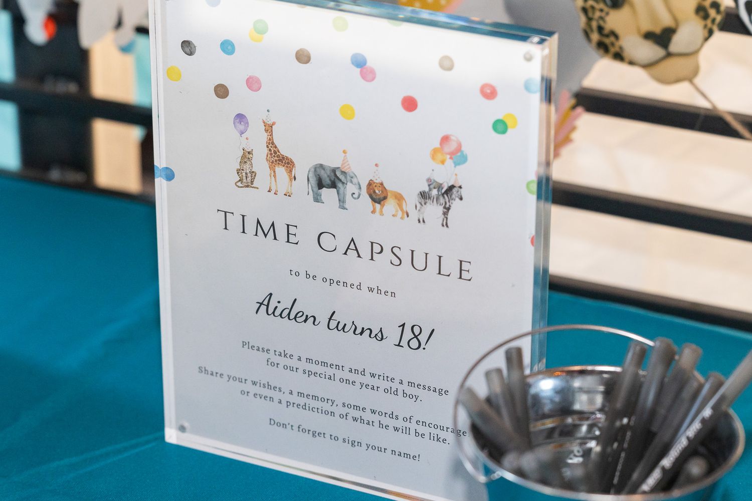 Time capsule sign with colorful polka dots and animal illustrations.