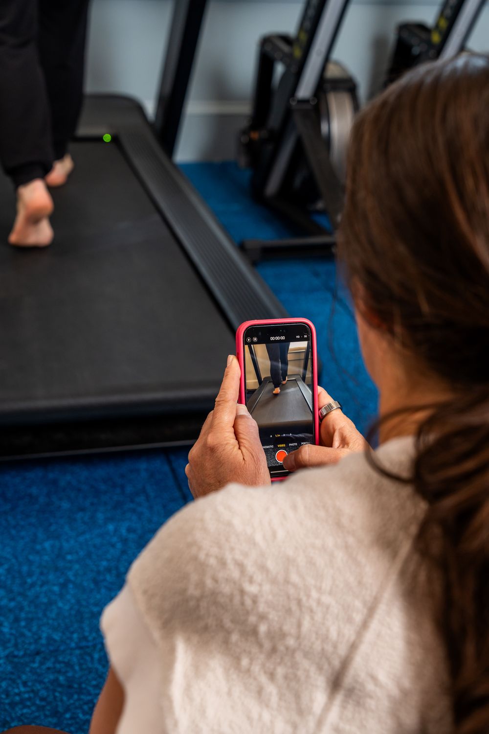A person using a mobile phone while sitting down indoors.