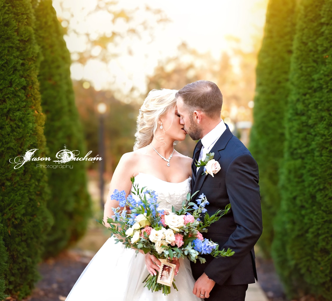 Four romantic wedding photos of newlyweds sharing intimate moments among evergreen trees in an outdoor garden setting.