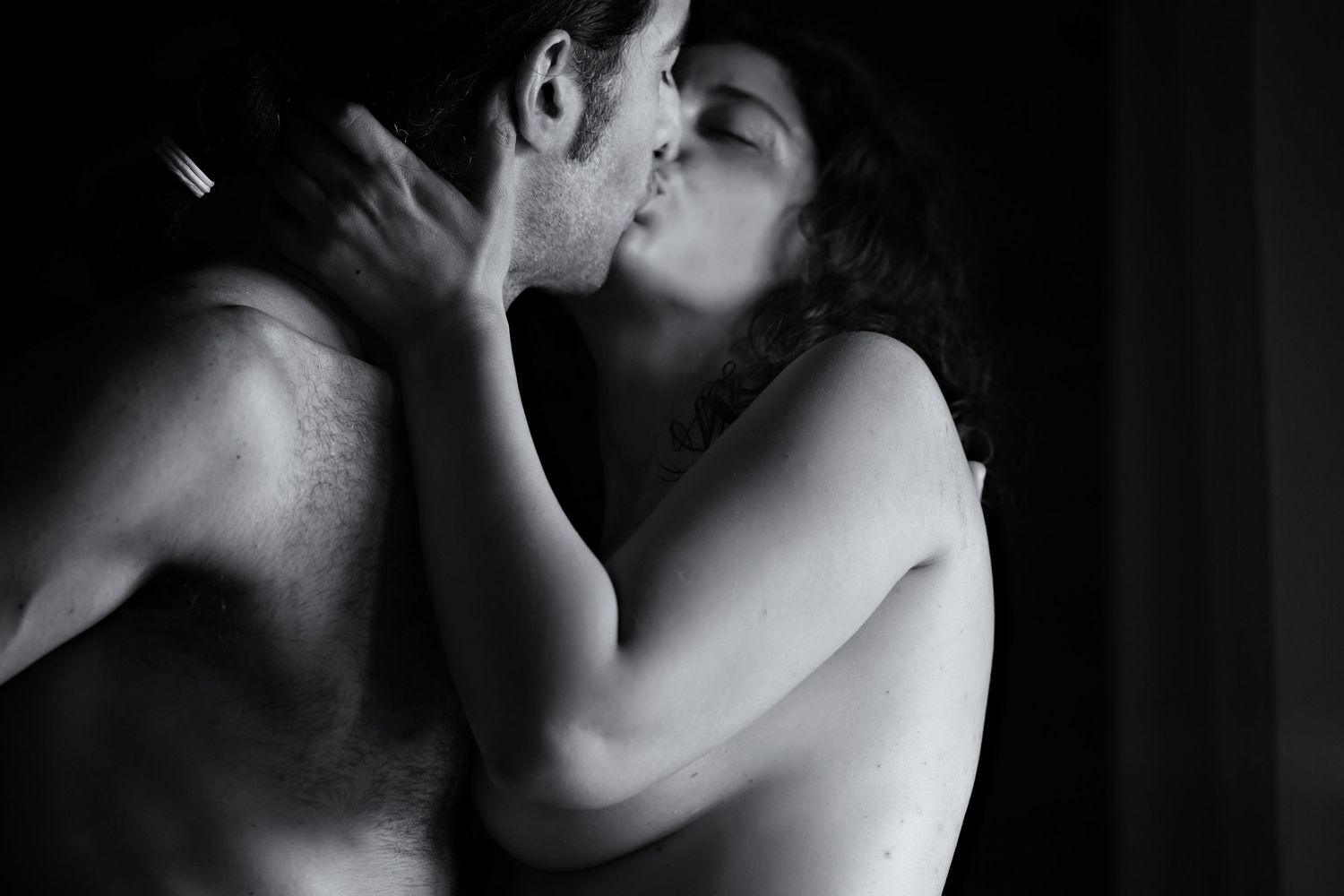 Black and white artistic portrait series showing intimate romantic moments between two figures in shadow.