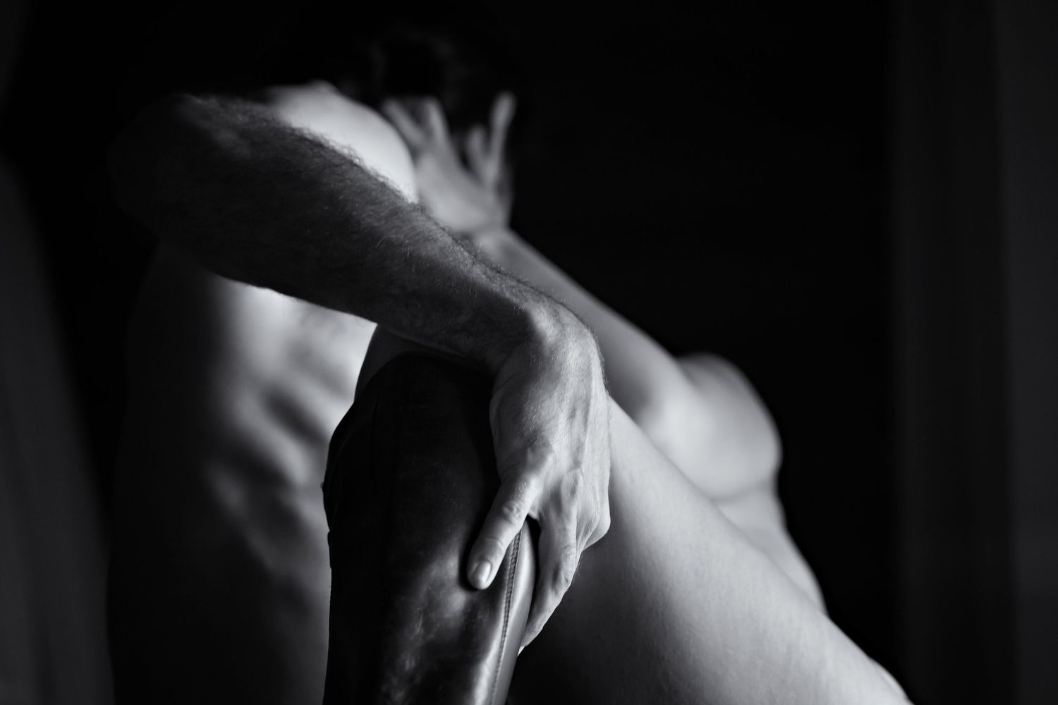 Black and white close-up photograph of a person's hands gracefully positioned.