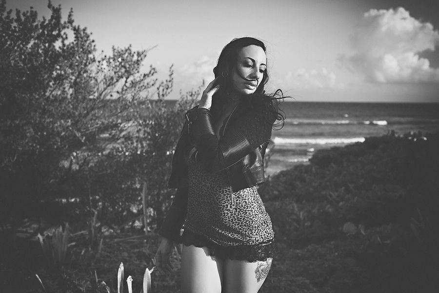 Series of black and white photos showing movement against a cloudy coastal landscape.