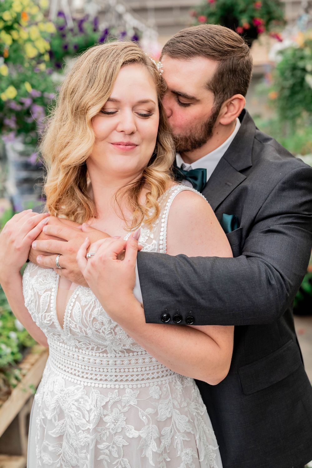 A romantic dance moment features a bride in a white lace gown with her partner in a dark suit.