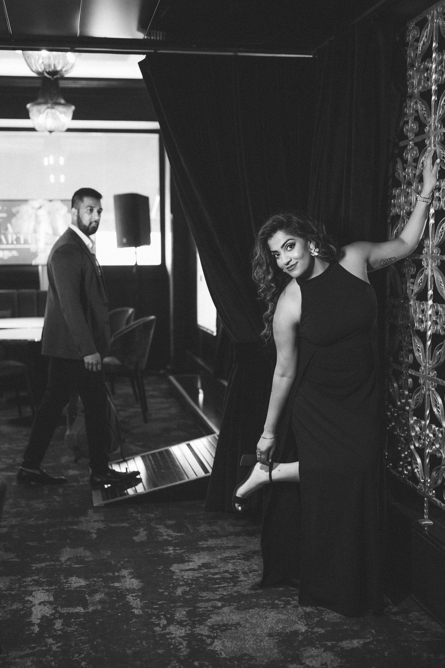 Cinematic couple portrait at the stylish Maxime Hotel bar in Lisbon during their engagement session.