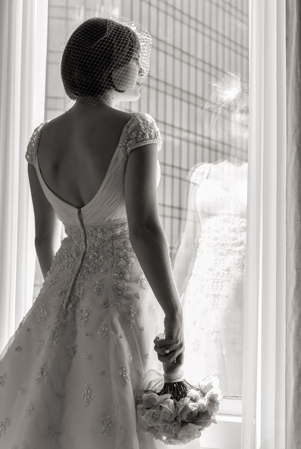 Detail shots of a lace wedding dress showing intricate beading and embroidery detail against a window background.