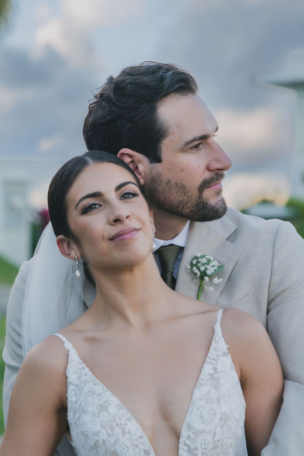 A romantic series of wedding photos showing tender moments between newlyweds against a cloudy sky background.