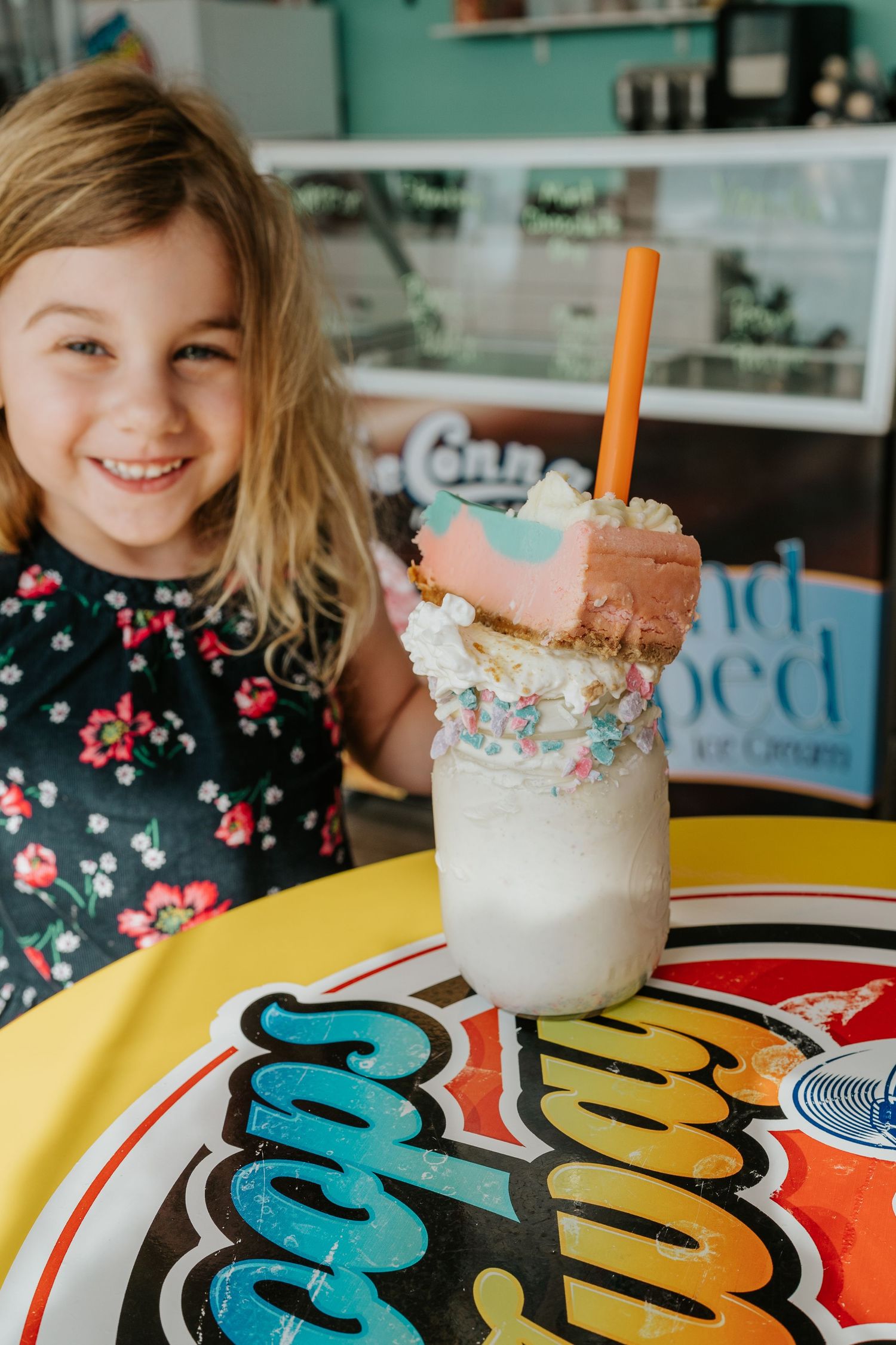 Golden hour photo of kid holding milkshakes Scoops Away Ice Cream in Brunswick, Georgia