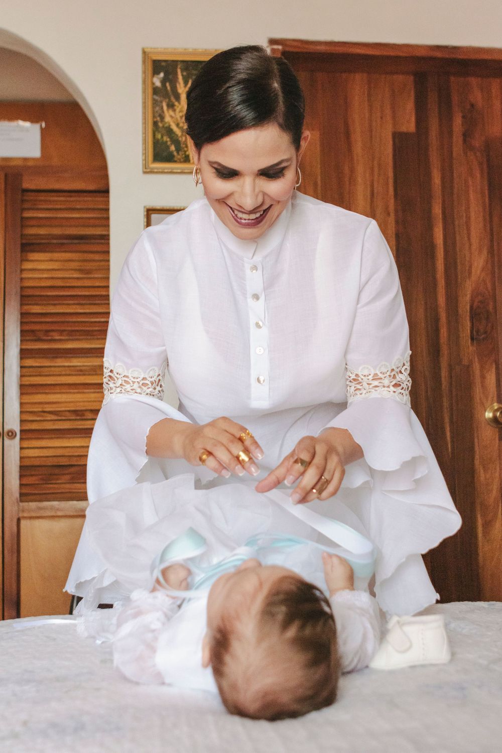 Baby boy getting ready for his baptism, captured by NYC family photographer Paula Ortiz.