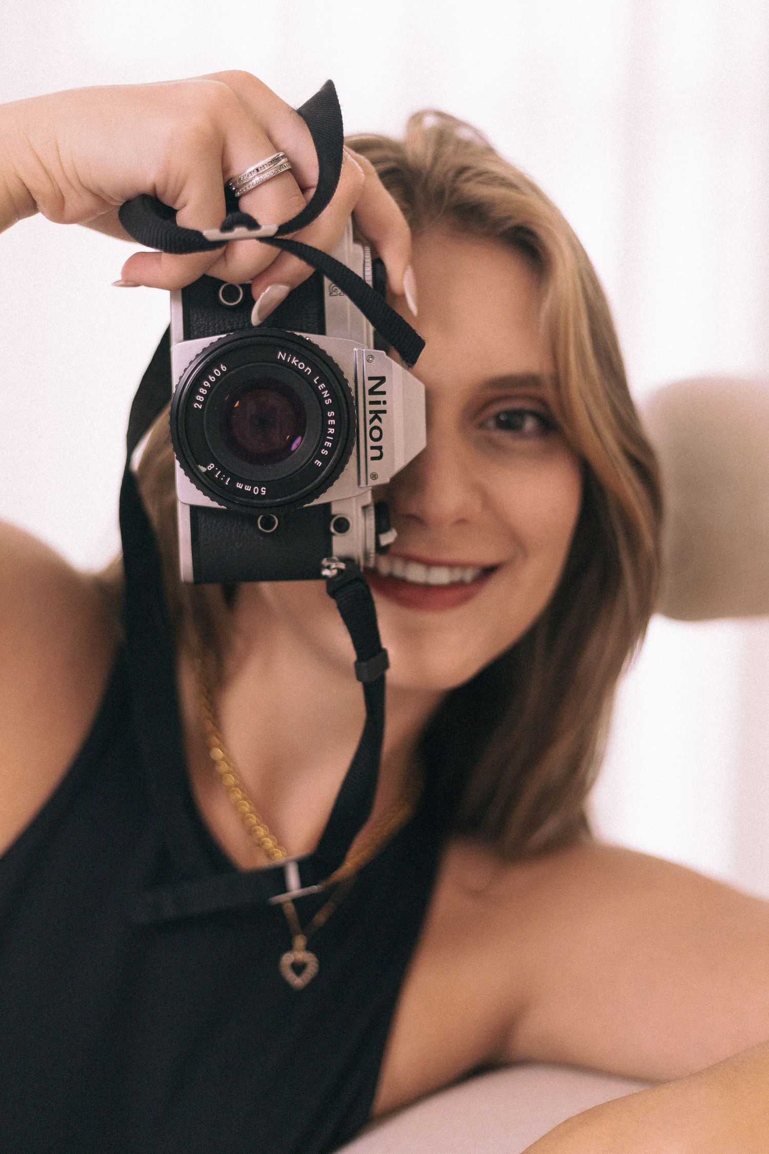 Branding Photography Sessions capture a creative entrepreneur holding a camera showcasing storytelling.