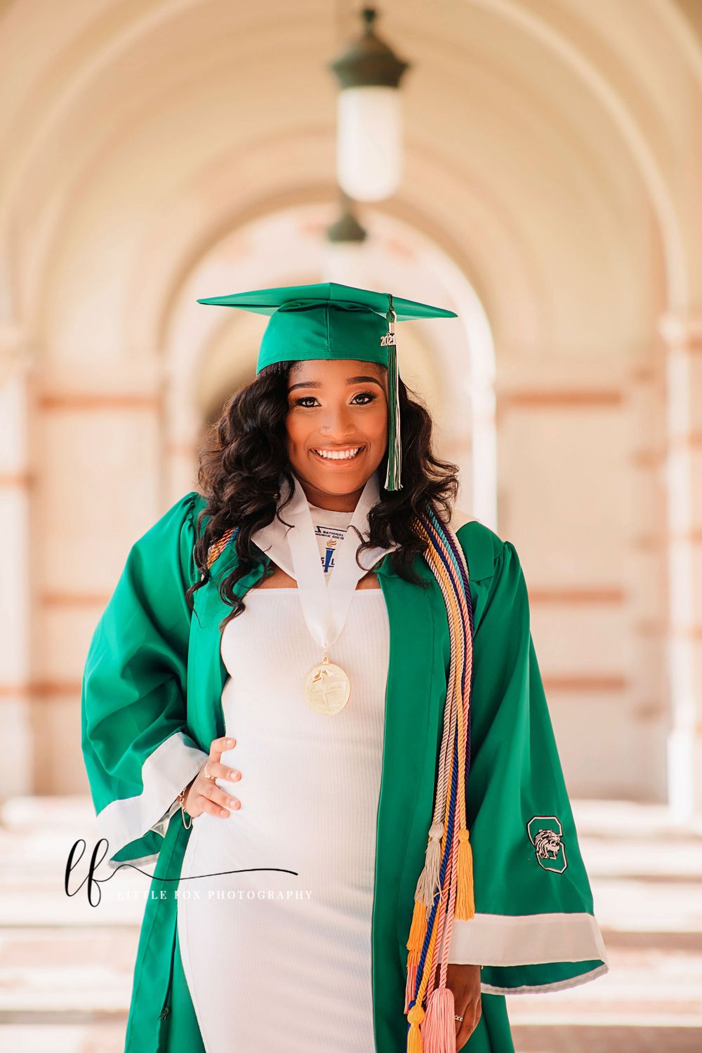 High school senior portrait of a young woman wearing graduation attire