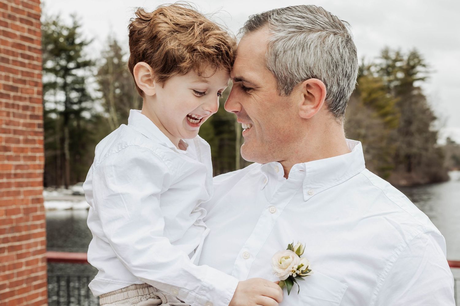 A joyful moment shared between parent and child, both wearing matching white shirts.