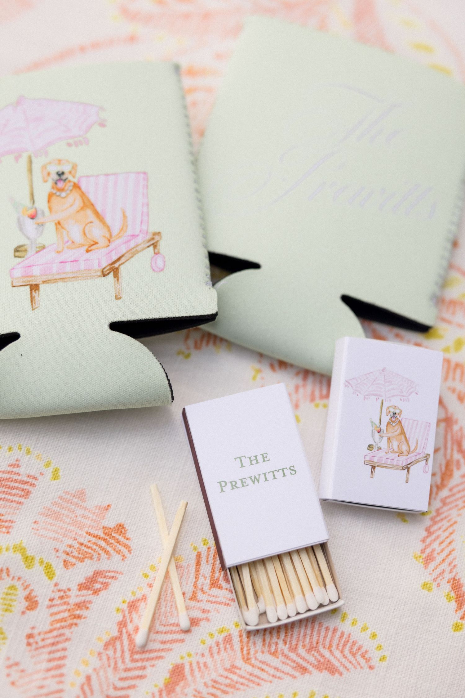 Wedding details flat lay with mint bow, sandals, perfume bottle and eucalyptus sprigs.