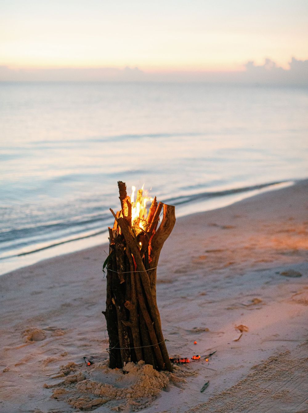Bright fire lighting up the beach at Amanpulo, Philippines.