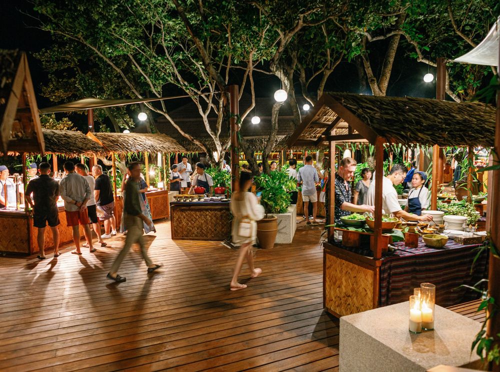 Wedding reception at Amanpulo, Philippines: A beautifully decorated outdoor venue with guests celebrating the newlyweds