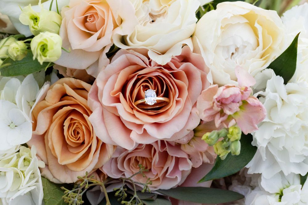 Wedding detail shot with ring in bouquet at lakeside pavilion in chico northern california wedding photograper