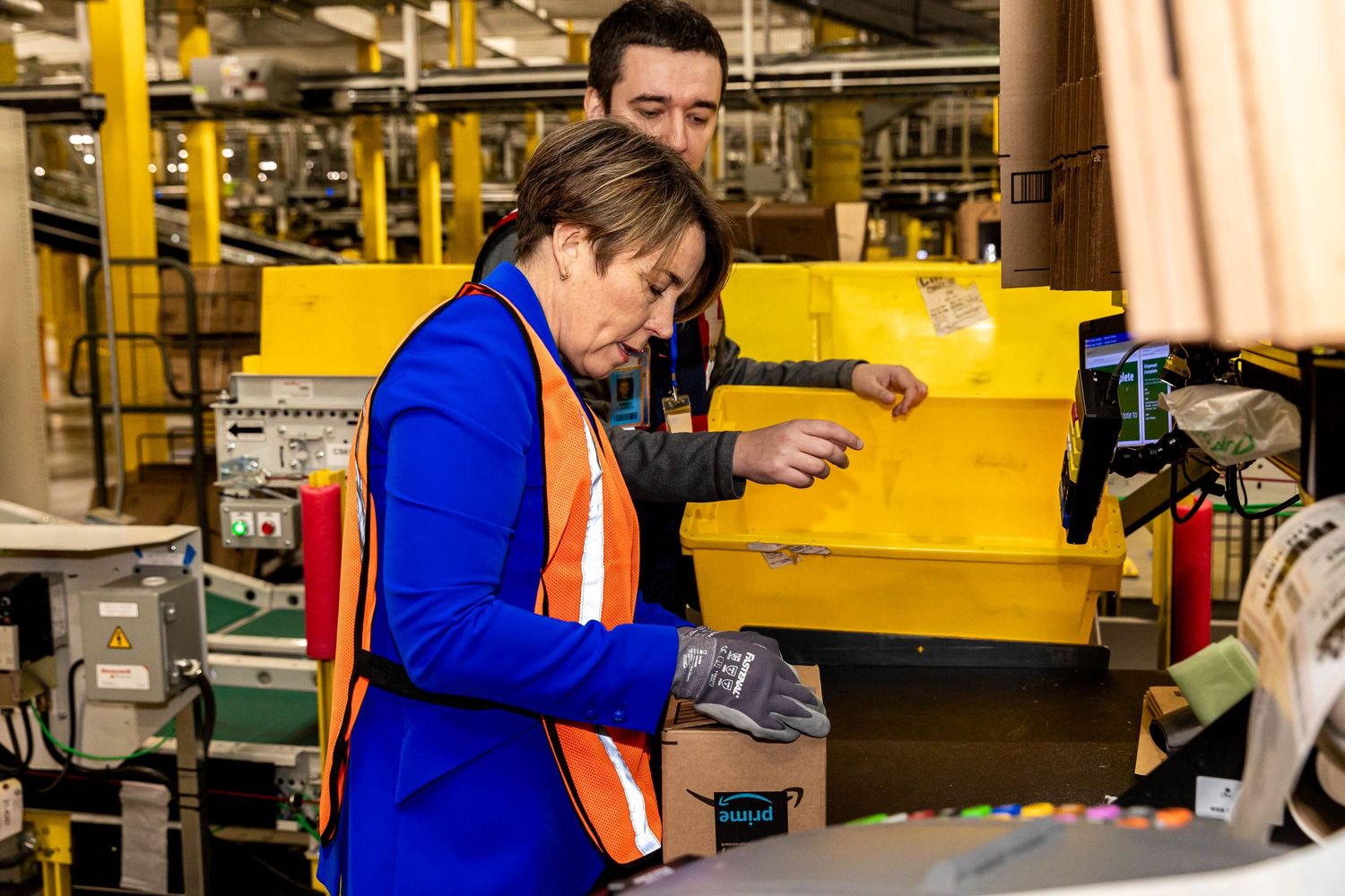 Person scanning items at a workstation in an Amazon fulfillment center.
