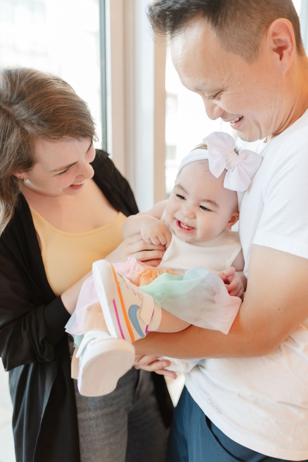 Heartfelt moment when parents play with baby at baby's first birthday in Toronto after a cake smash, captured by Jess GC Photography