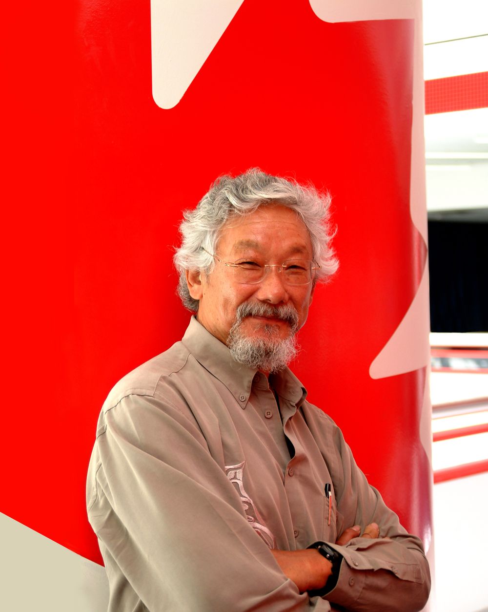 Portrait against red and white backdrop showing Canadian flag maple leaf design.
