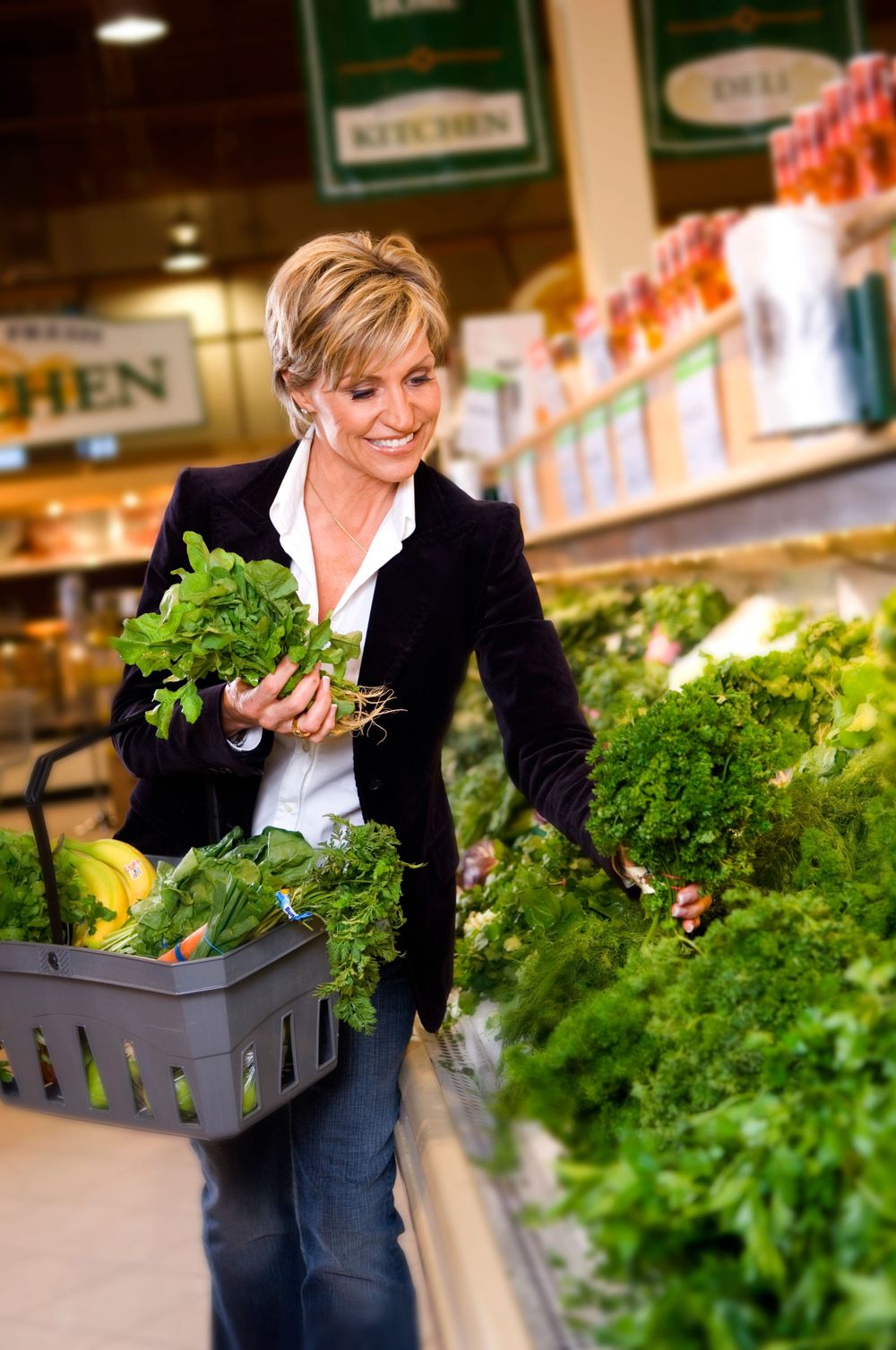 Professional shopper selecting fresh produce in a grocery store produce department.