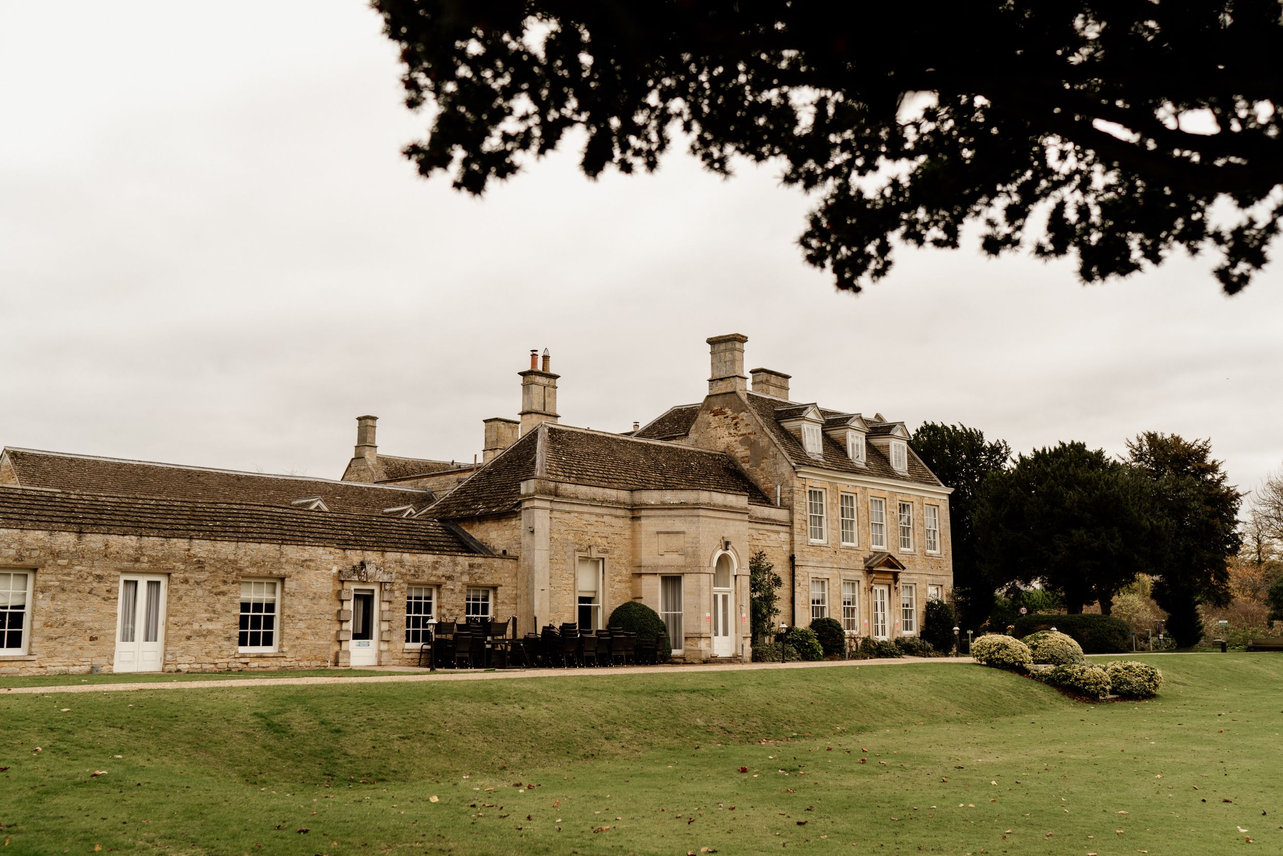 Stately manor house of Barton Hall wedding venue with manicured lawns and classic architecture.