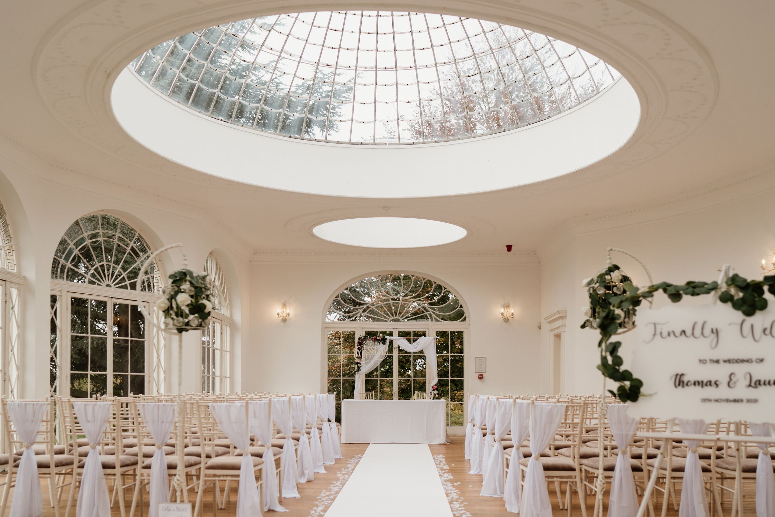 Barton Hall Elegant wedding orangery setup in a bright conservatory with domed glass ceiling.
