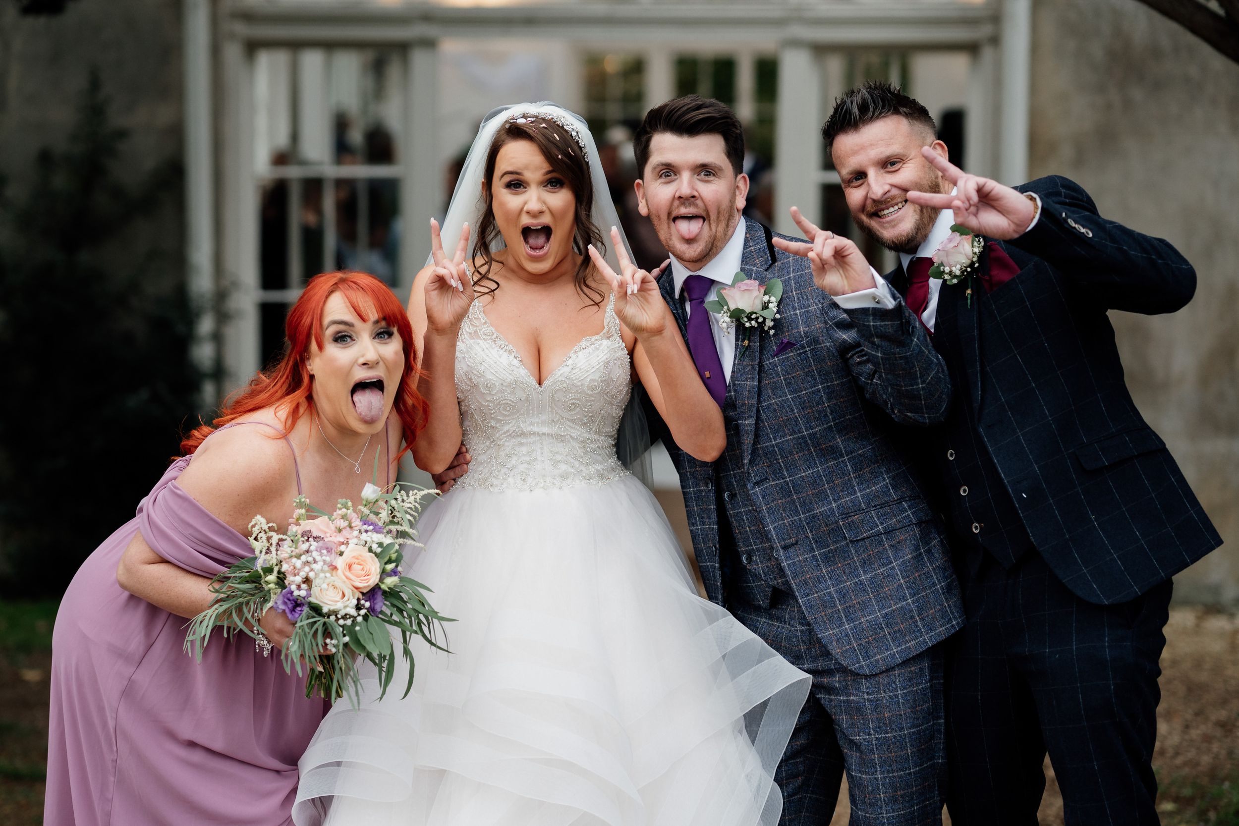 Fun group photo showing wedding party members making expressive faces.