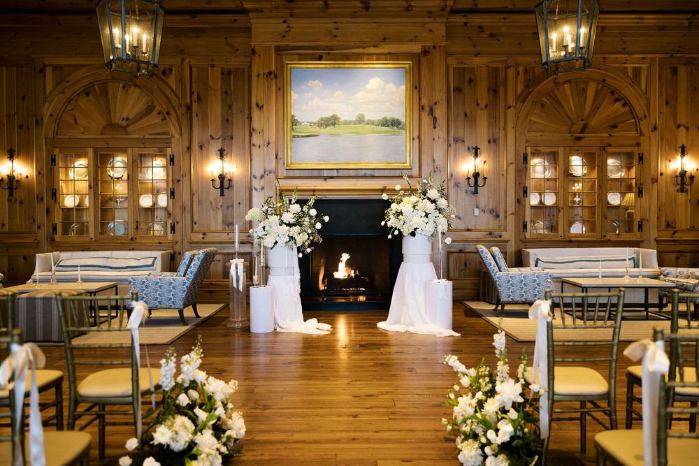 Elegant rustic wedding ceremony setup with wooden walls, fireplace and floral arrangements. NC WEDDING PHOTOGRAPHER, LUXURY WEDDING PHOTOGRA