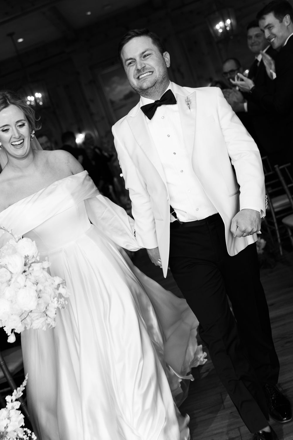 Black and white photograph of a joyous wedding celebration on a dance floor. NC WEDDING PHOTOGRAPHER, LUXURY WEDDING PHOTOGRAPHER