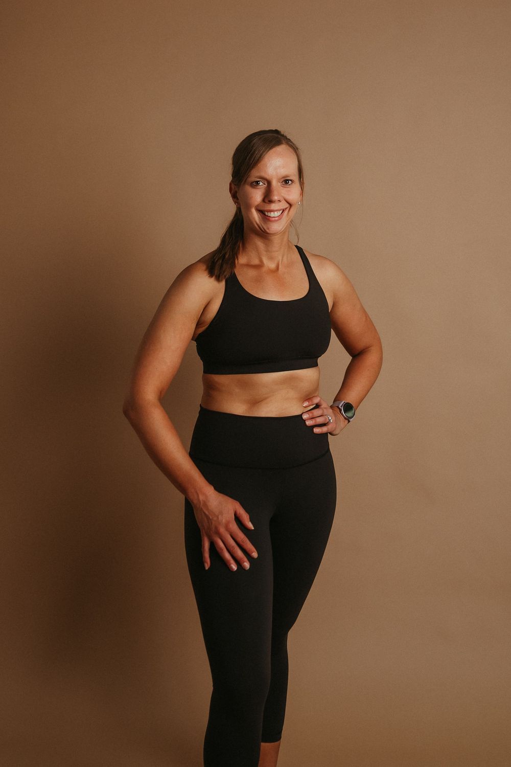 Side-by-side photos show fitness progress comparison in black workout attire against brown backdrop.