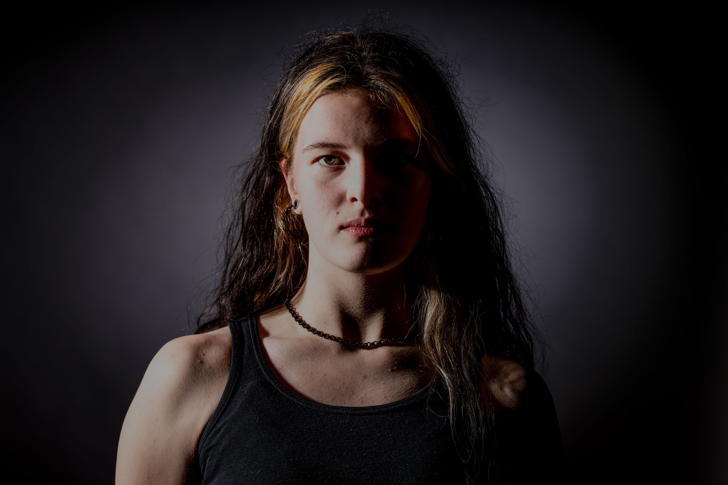 Dramatic, lighting, showing side lighting with a center light on the background