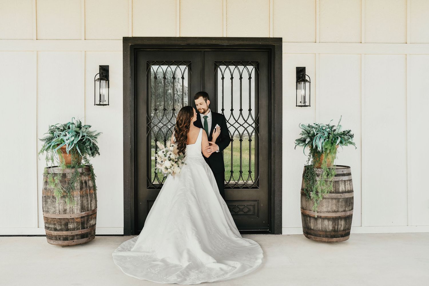 Wedding day portrait at The Madelyn’s iconic black barn entrance