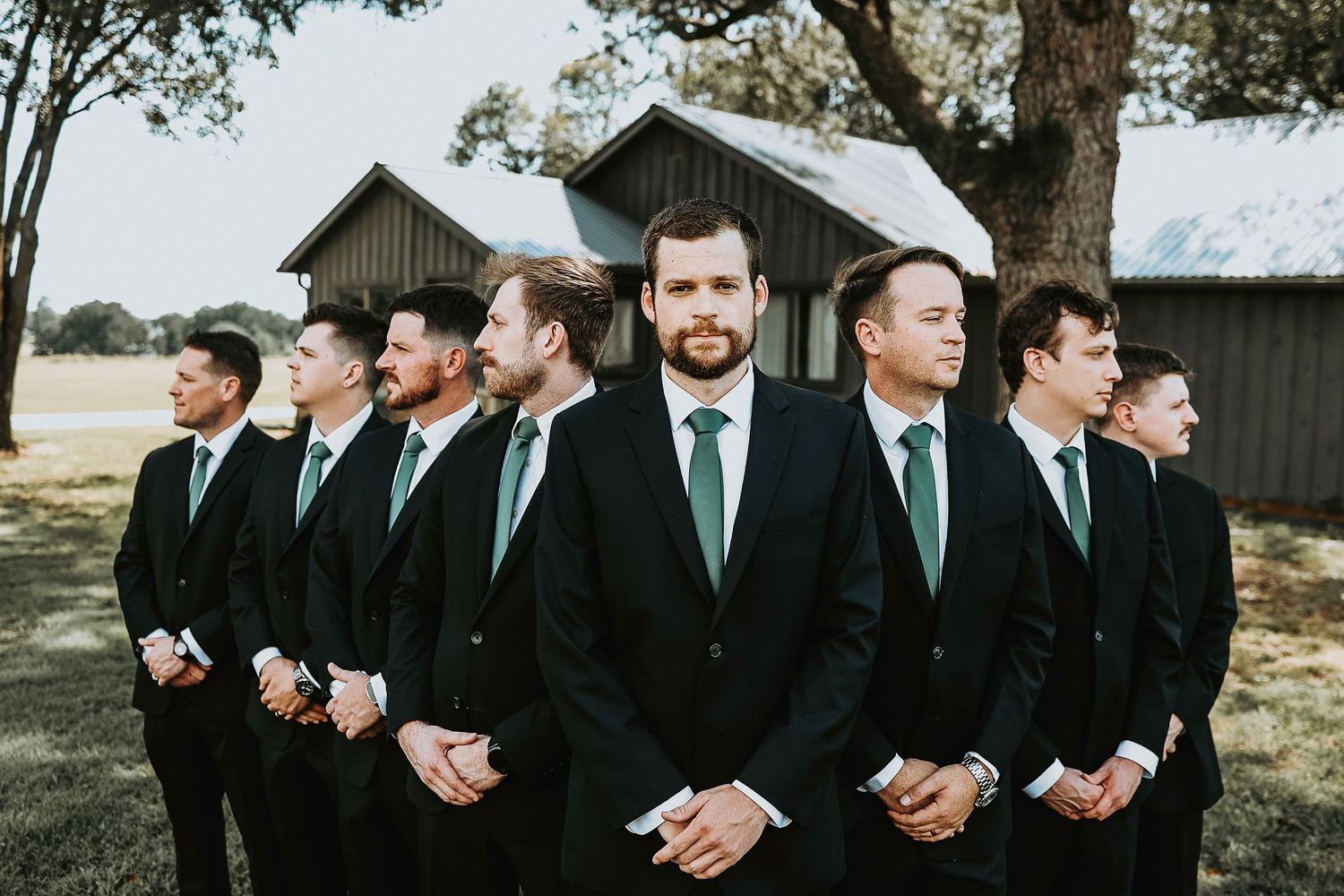Stylish groom with groomsmen in matching suits at The Madelyn
