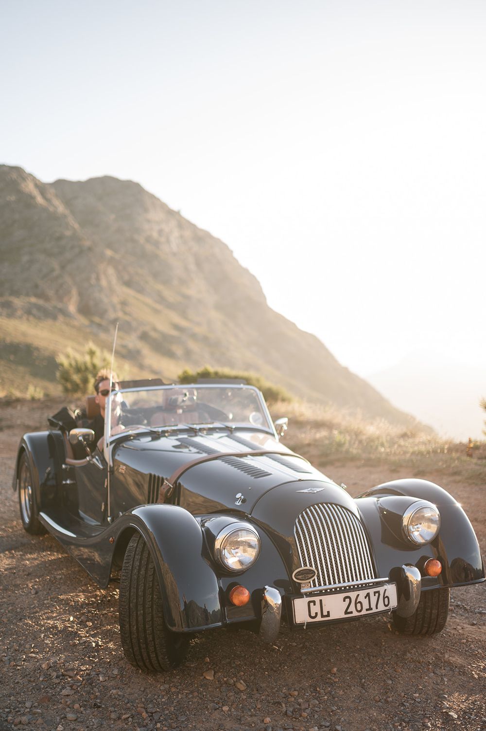 Intentional Franschhoek, Cape Town engagement session capturing soulful, effortless love with warm spring light, fun and a old school car.