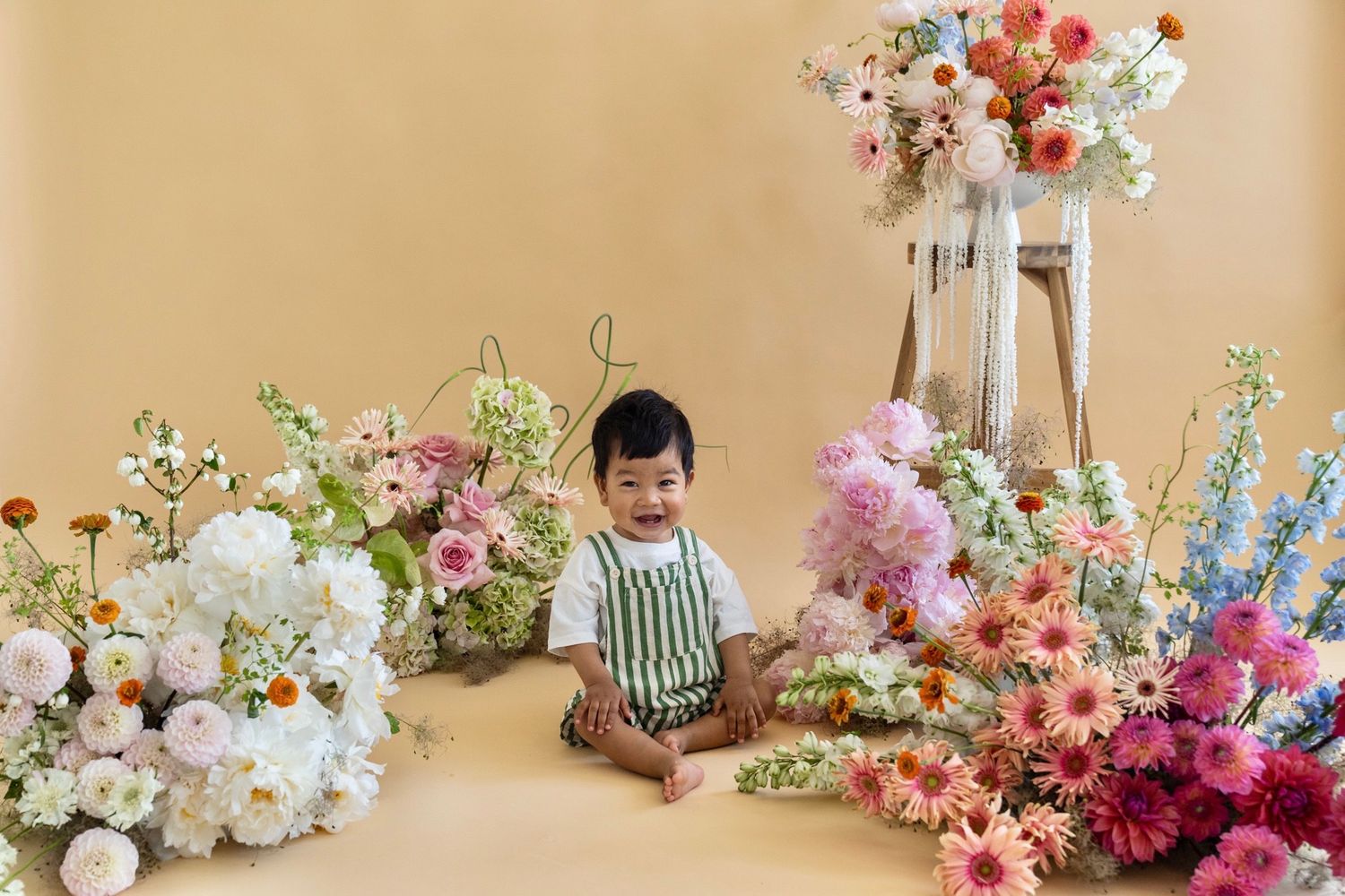 Colorful and whimsical floral arrangements featuring pink, white and purple blooms in a professional studio setting.