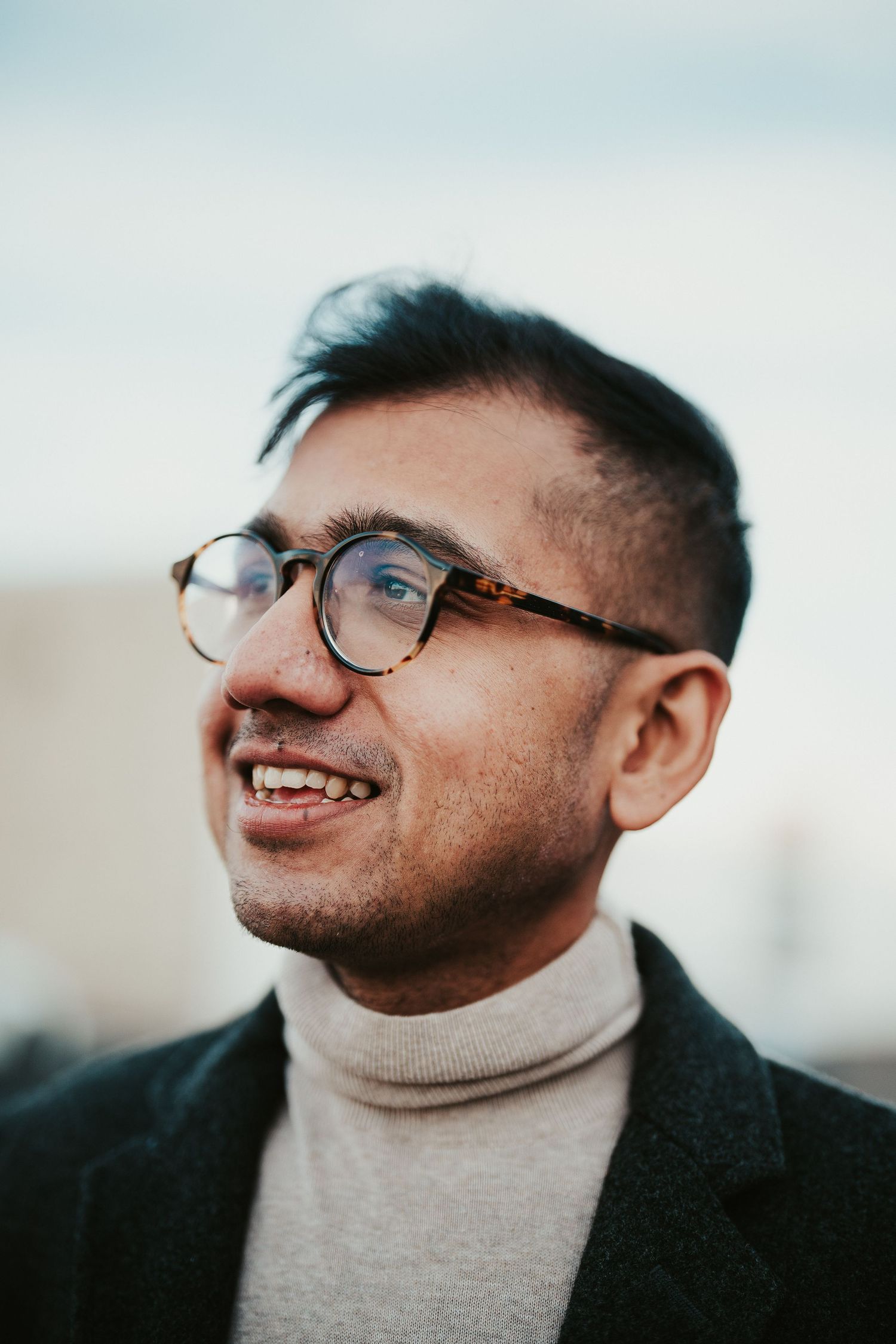 Outdoor portrait in warm sunlight with shallow depth of field and bokeh background.