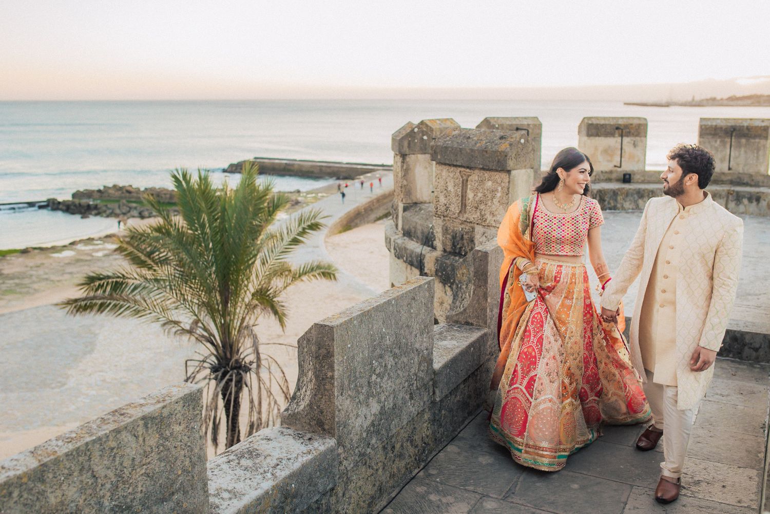 A romantic moment between the bride and groom during their Indian Destination Wedding in Portugal at Forte da Cruz