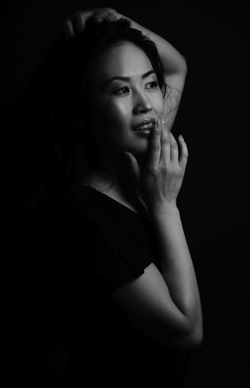 Dramatic black and white portrait of Mai featuring soft lighting and shadows in a moody artistic style photographed by Evan Will of Sharko