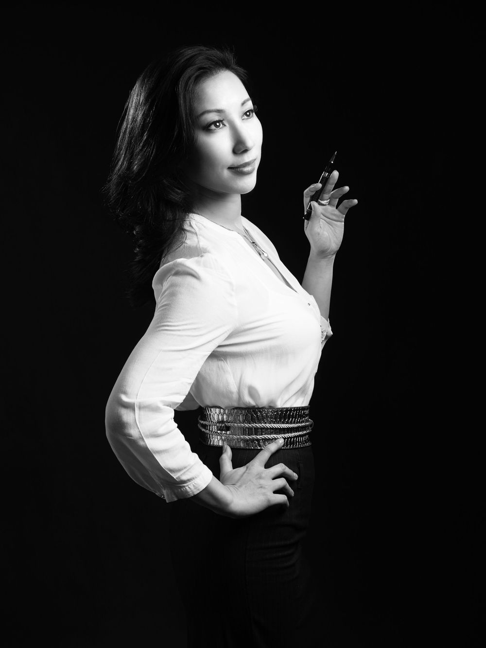 A black and white portrait of Kanon in a white blouse and dark skirt styled in classic 1950s fashion photographed by Evan Will
