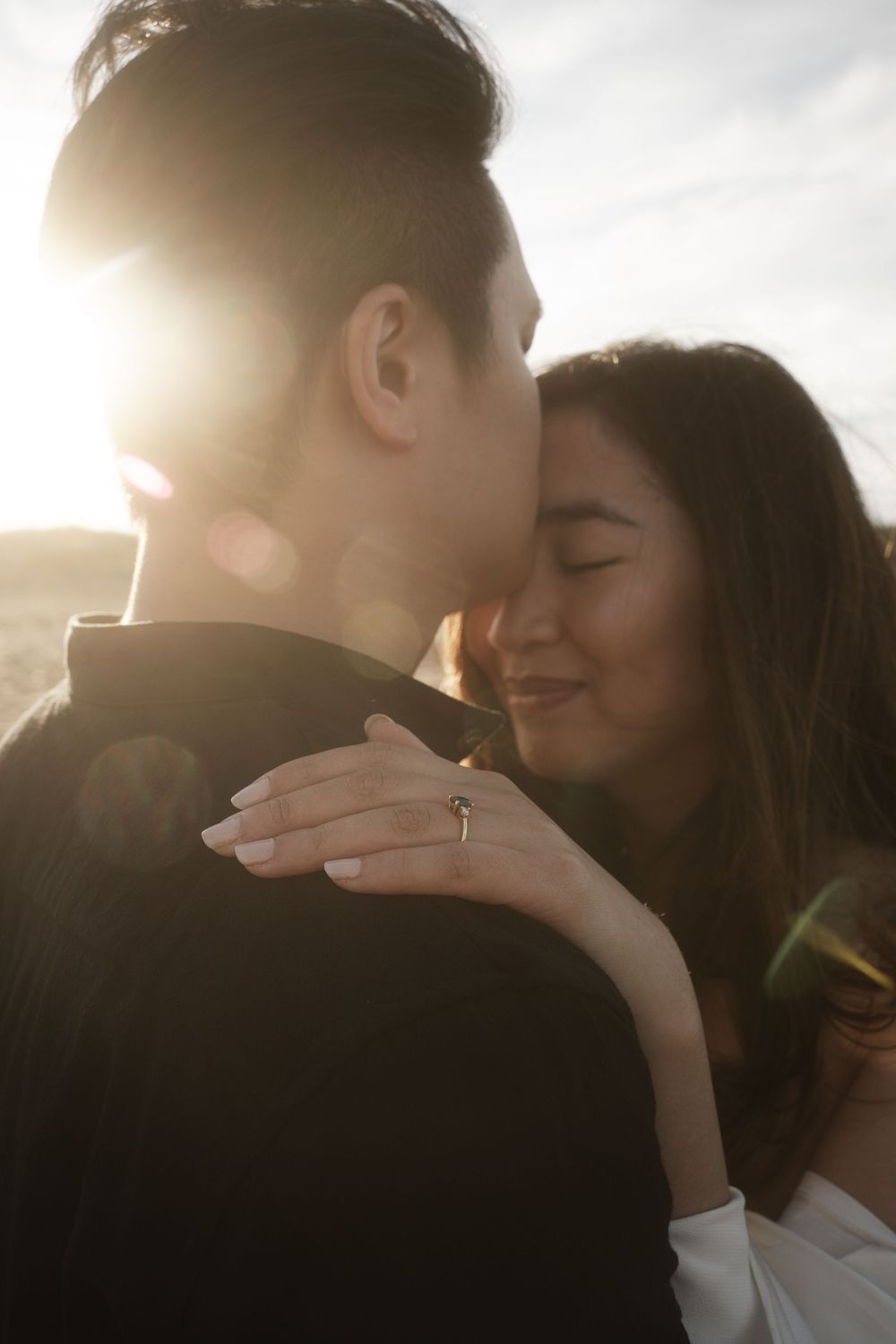A romantic couple shares intimate moments in backlit sunlit photos.