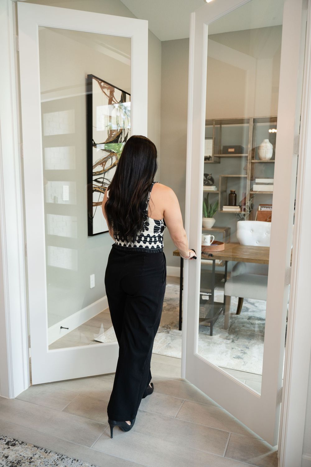 Interior design reveal showing modern dining room and living spaces in transitional style with neutral colors and built-in shelving.