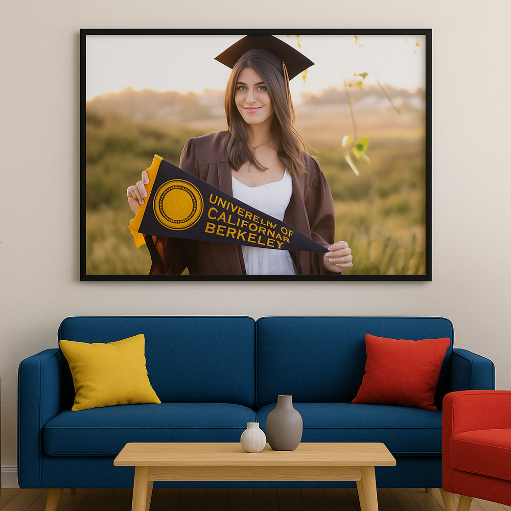A sleek navy blue sofa with red and yellow accent pillows sits beneath a gallery wall of graduation photos.
