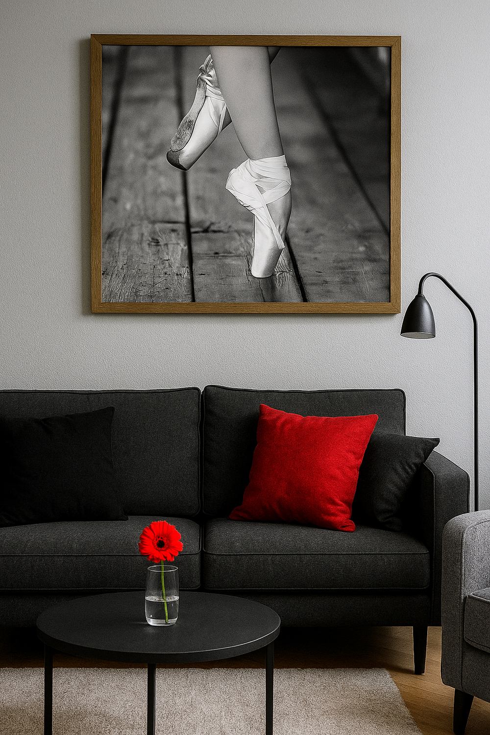 A black and white ballet pointe shoe photograph hangs above a gray couch with red accent pillow and poppy flower decor.