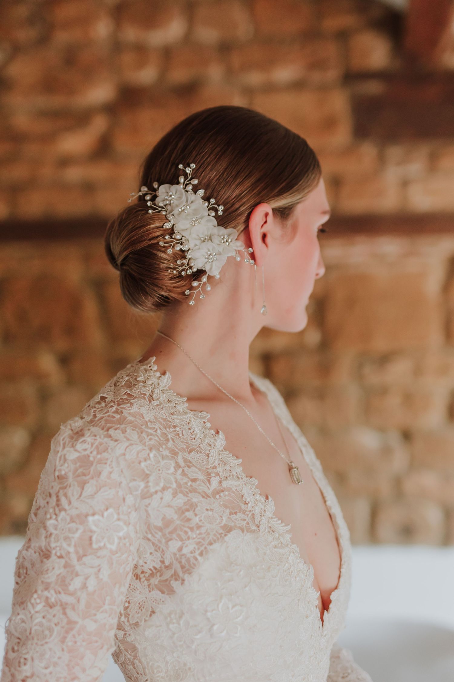 A bridal look with white lace dress and delicate hair accessories