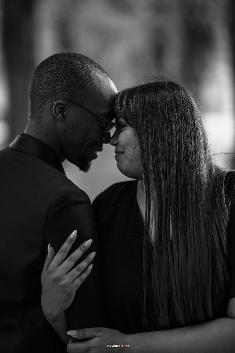 A romantic black and white portrait of an intimate couple sharing a tender moment together.