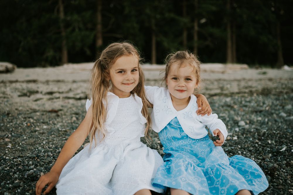 Comox Valley family photographer photoshoot of girls sitting in rocks Kye Bay Beach Portraits taken by photographer Soulfull Photographs
