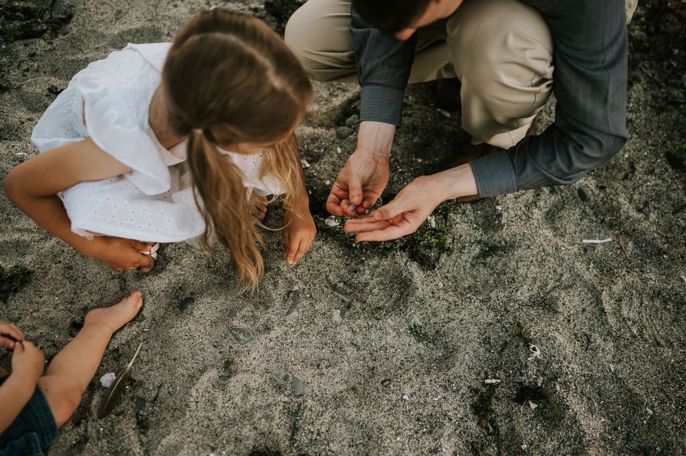 Comox Valley family photographer candid photo of kids holding crabs at Kye Bay Beach portraits taken by photographer Soulfull Photographs