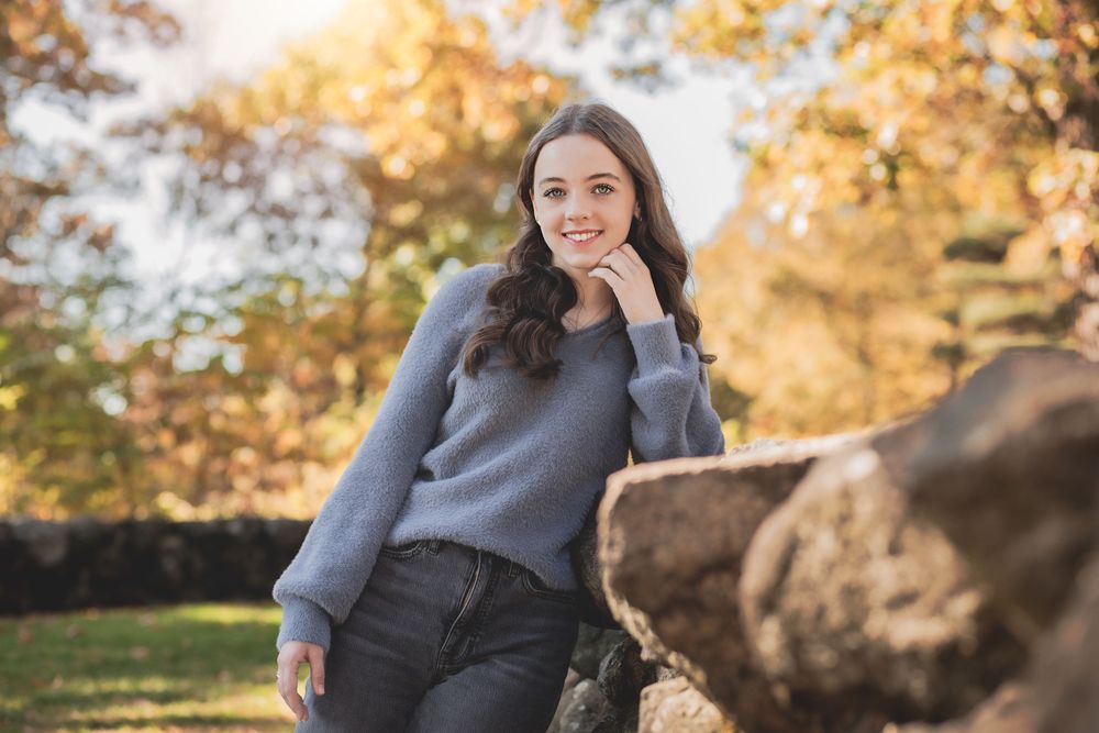 A sequence of autumn portraits showing someone wearing a grey sweater with soft lighting and fall foliage in the background.