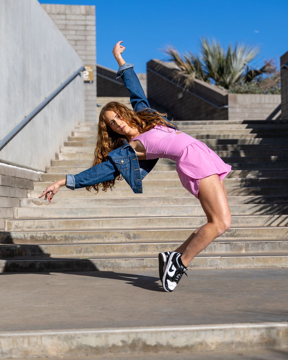 A dancer hits a dramatic dance pose outdoors in Phoenix, Arizona